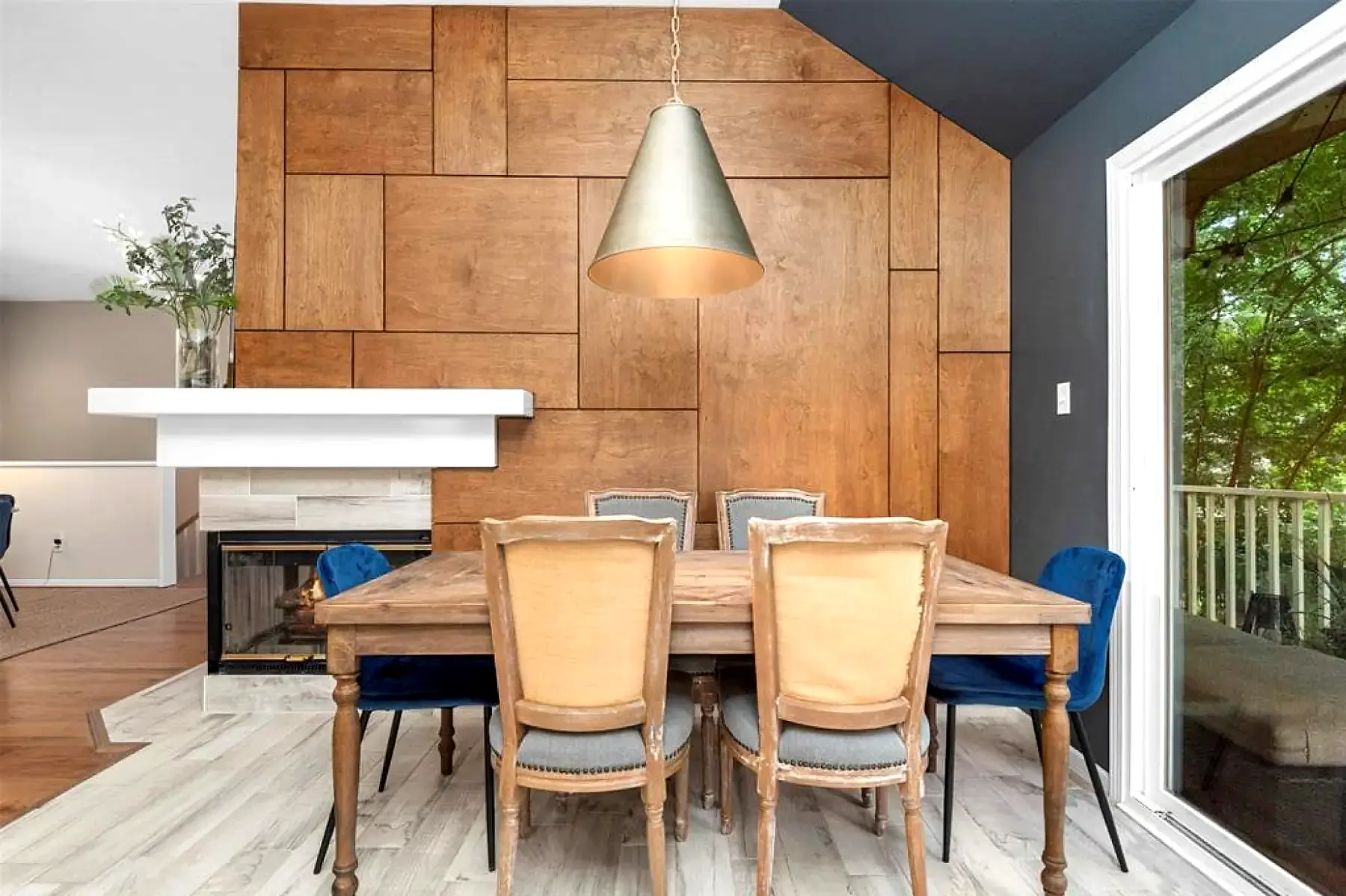 Geometric wood feature wall beside a fireplace