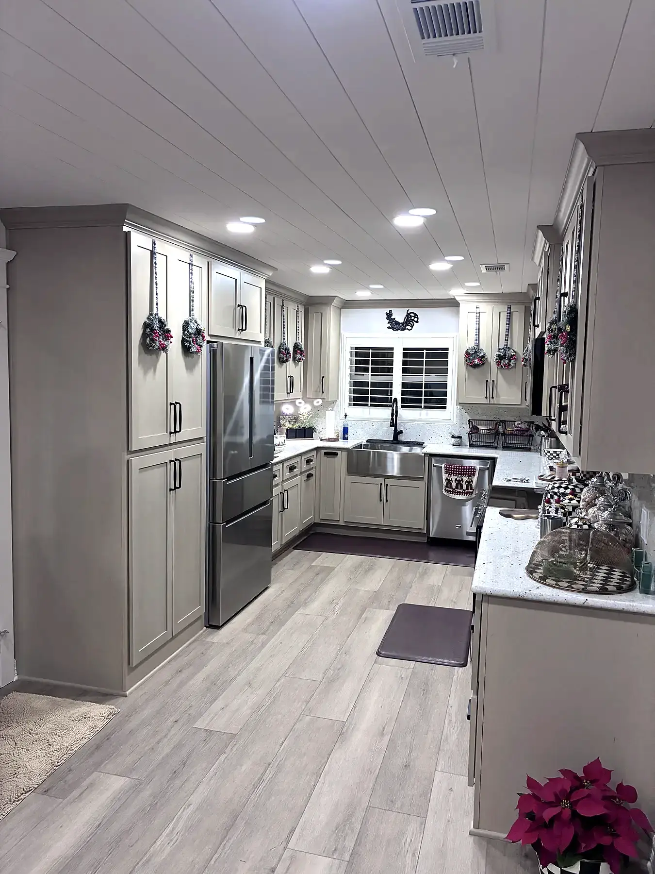 Updated gray kitchen with an island and extensive custom cabinetry