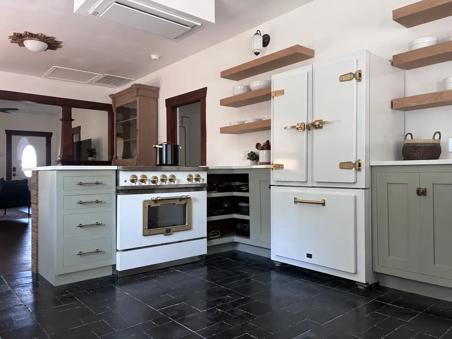 Finished Tomball kitchen range wall with inset cabinetry and vintage appliances